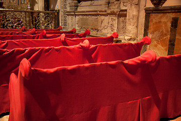 Image showing Red sheets on some benches 