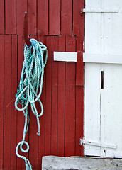 Image showing Green rope on a wooden building