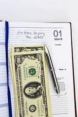 Image showing writing down in a notebook about a debt