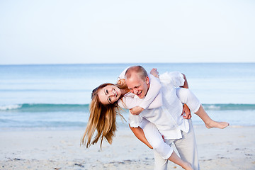 Image showing happy couple in love having fun on the beach