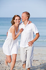 Image showing happy couple in love having fun on the beach