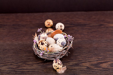 Image showing easter decoration with quail eggs on wood