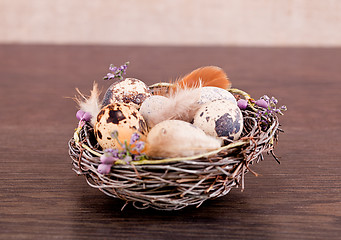 Image showing easter decoration with quail eggs on wood