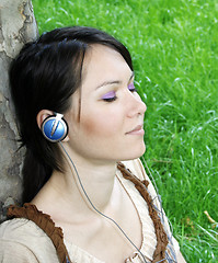 Image showing Young woman listening music