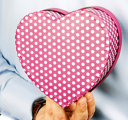 Image showing Businessman hiding a gift