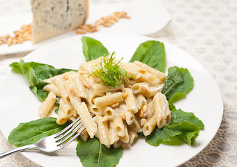 Image showing Italian pasta penne gorgonzola and pine nuts