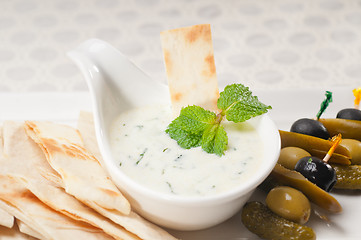 Image showing Greek Tzatziki yogurt dip and pita bread