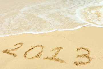 Image showing 2013 written in sand on beach 