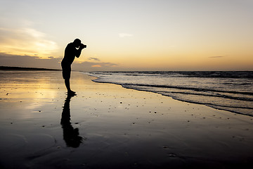 Image showing photographer at the sunset beach