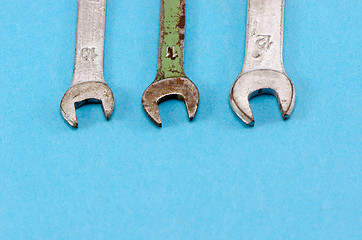 Image showing three screw spanners wrench tools blue background 