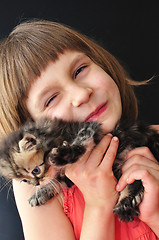 Image showing happy little girl with a cat