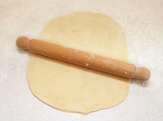 Image showing Block of freshly made pastry rolled out on a floured work surfac