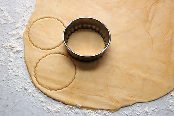 Image showing Metal cutter cutting out circles of pastry for jam tarts