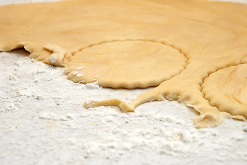 Image showing Detail of circles being cut from a sheet of fresh pastry