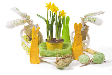 Image showing Yellow narcissus in the pot and five bunnies