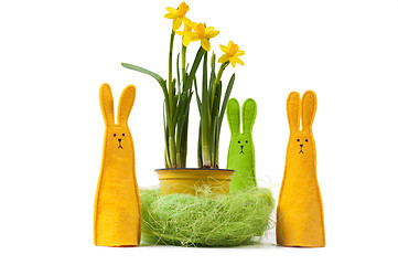 Image showing Yellow narcissus in the pot and three bunnies