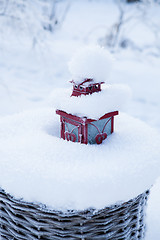 Image showing Red lantern in snow filled basket