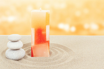 Image showing Balance zen stones and candle in sand on bokeh 