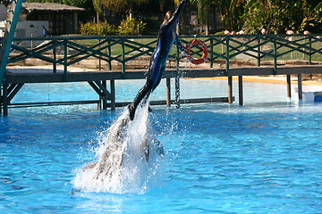 Image showing girl pushed up by a dolphin