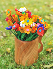 Image showing Bouquet multicolored artificial flowers in a vase