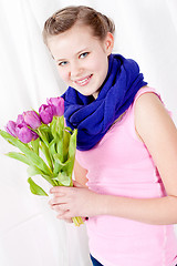 Image showing smiling teenager girl with pink tulips bouquet 