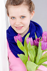 Image showing smiling teenager girl with pink tulips bouquet 