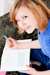 Image showing happy teenager girl doing homework 