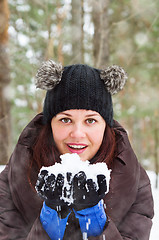 Image showing Cute young woman playing with snow  outdoors