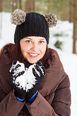 Image showing Cute young woman playing with snow  outdoors