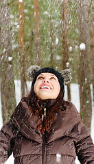 Image showing Cute young woman playing with snow  outdoors