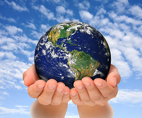 Image showing Woman holding globe on her hands, South and North America