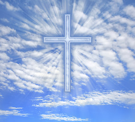 Image showing Christian cross with light beams over sky