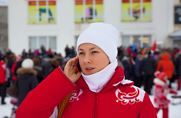 Image showing The girl speaks on a mobile phone about sale in the supermarket