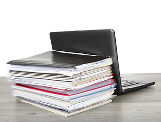 Image showing Many files and a computer on a desk 