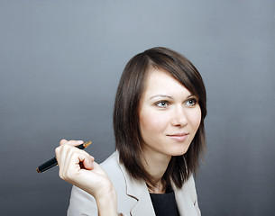 Image showing Woman holding a pen 