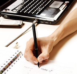 Image showing Businesswoman writing