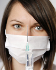 Image showing Nurse in mask with syringe 