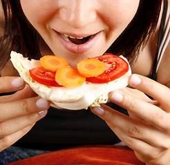 Image showing Woman eating a sandwich 