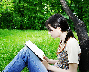 Image showing Young woman reading a novel 