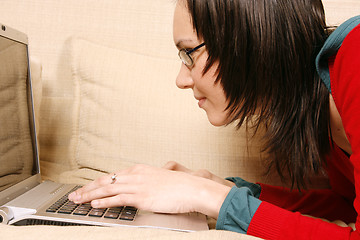 Image showing Girl with laptop on the sofa 