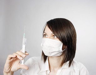 Image showing Nurse in mask with syringe 
