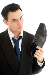 Image showing salesman with black leather boot