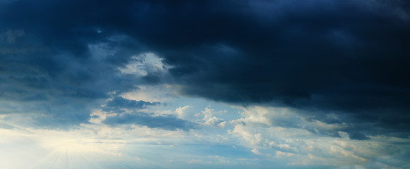 Image showing Panorama - sunbeams in stormy dark cloudy sky