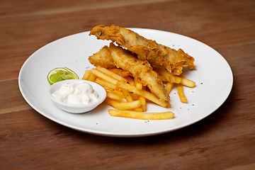 Image showing Shrimp tempura dish with white sauce and fried potatoes