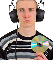Image showing Sad disappointed man with big headphones and CD