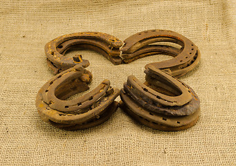 Image showing concept clover retro horseshoes linen background 