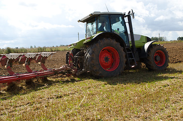 Image showing tractor closeup plow furrow agriculture field 