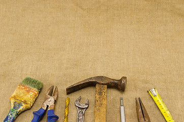 Image showing different retro construction work tools on linen 