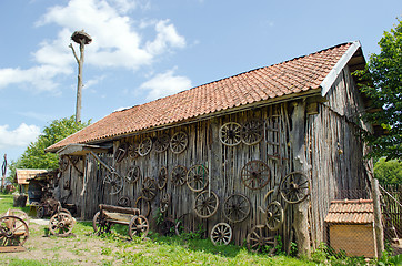 Image showing retro carriage wheel barn house bench stork nest 