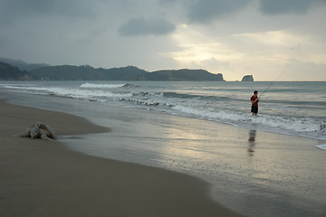 Image showing the fisherman. sunset on pacific ocean